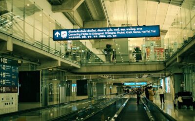 View of airport interior with moving walkway connecting flights