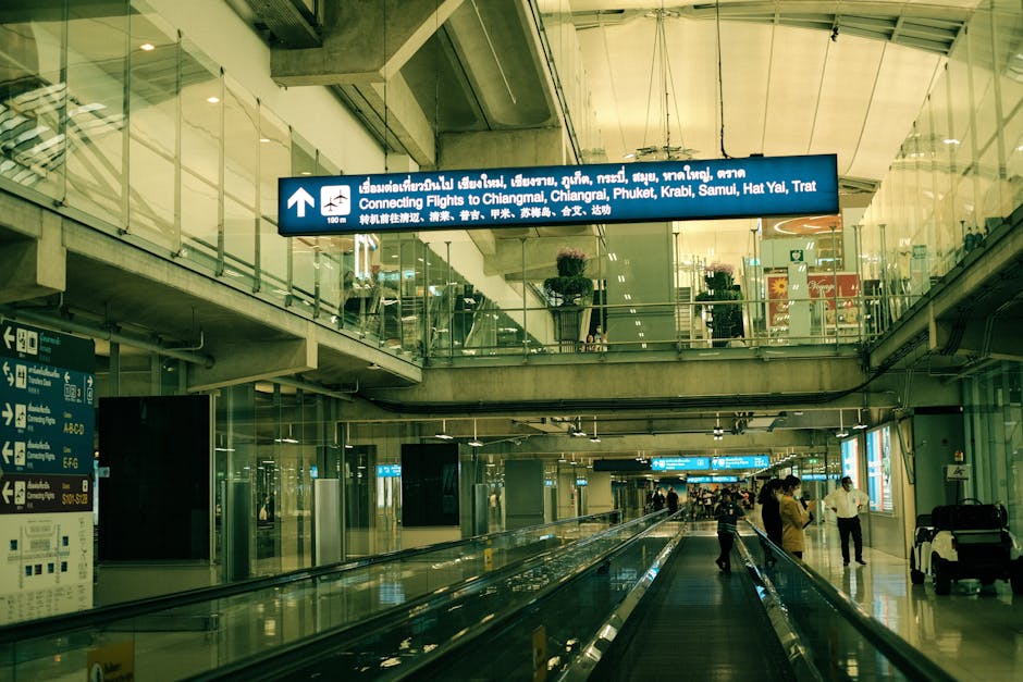 View of airport interior with moving walkway connecting flights