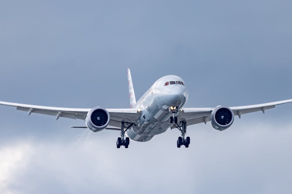 Airplane gliding through a cloudy sky during approach and landing