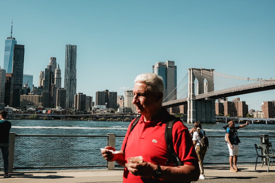 Tourists viewing the Brooklyn Bridge and Manhattan skyline
