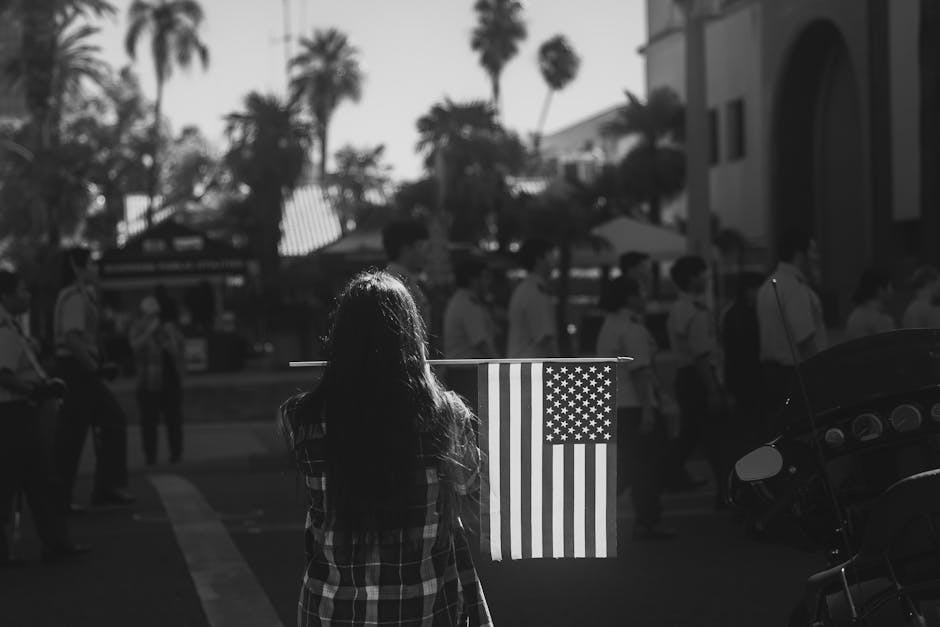 Memorial Day weekend - woman holding American flag at parade event
