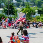 Memorial Day weekend - Boy Scout proudly carries American flag during community event