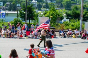 Memorial Day weekend - Boy Scout proudly carries American flag during community event