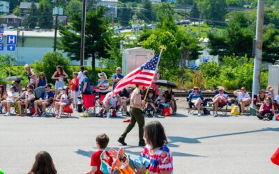 Memorial Day weekend - Boy Scout proudly carries American flag during community event