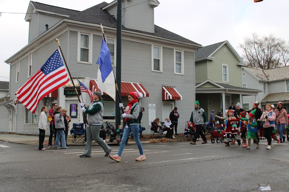 Memorial Day weekend - lively holiday parade with participants carrying flags