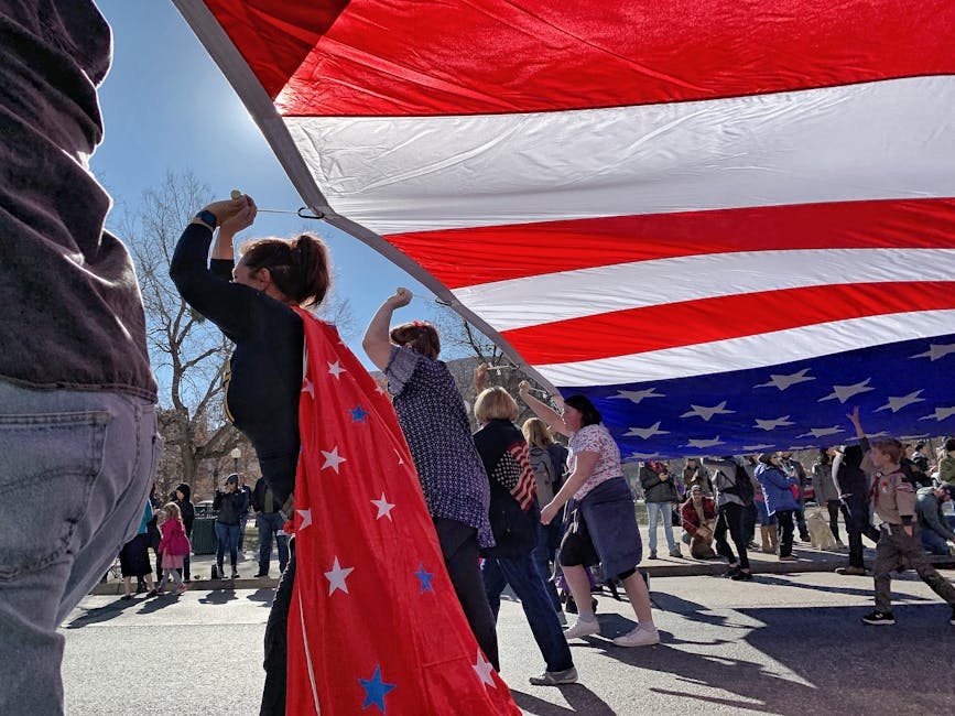 Memorial Day weekend - people celebrating under massive American flag at parade