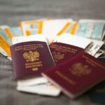 Traveler holding passport and boarding pass before the ESTA application deadline