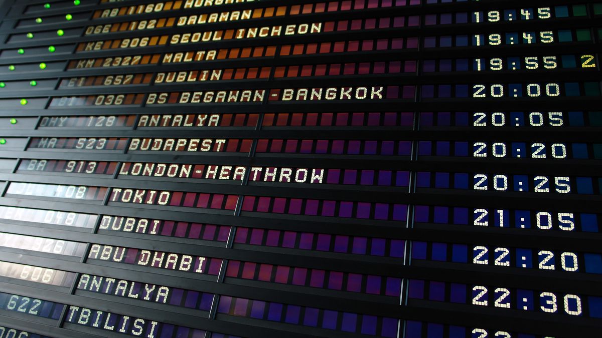 Airport departure board showing international flights to the United States