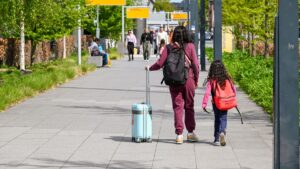 Family with children at the airport completing an ESTA application for children