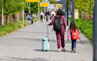 Family with children at the airport completing an ESTA application for children