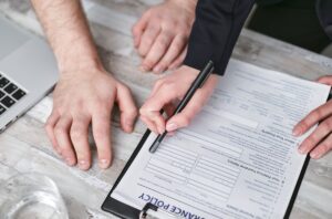 Traveler holding a passport and travel insurance documents before a US trip