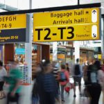Travelers in an airport transit hall affected by ESTA transit refused rules