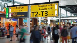 Travelers in an airport transit hall affected by ESTA transit refused rules