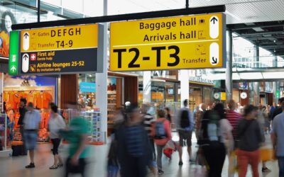 Travelers in an airport transit hall affected by ESTA transit refused rules