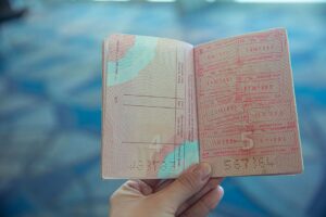 US border officer reviewing a passport, where your ESTA I-94 record is created on arrival
