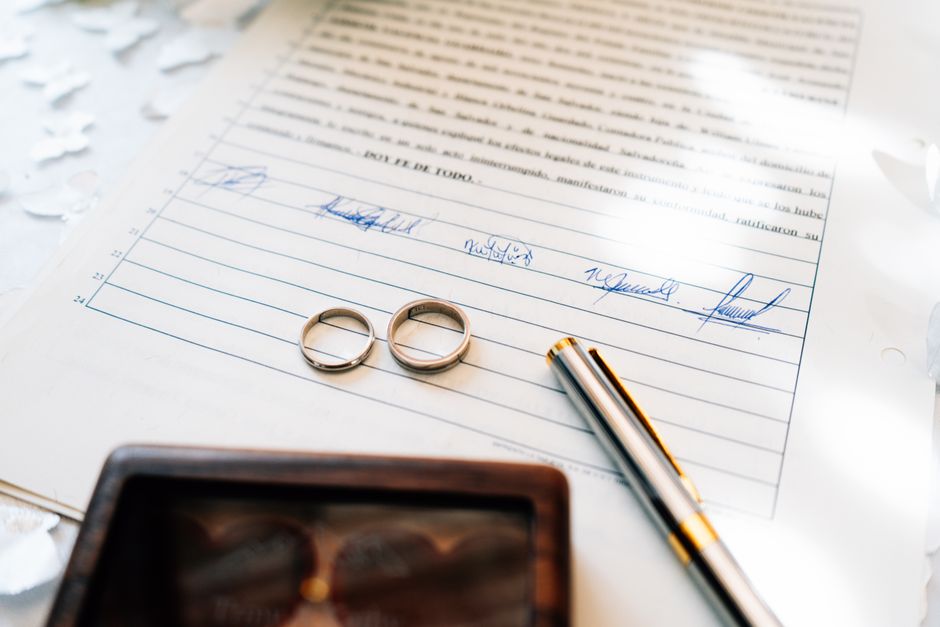 Wedding rings beside marriage paperwork for an ESTA visitor wedding