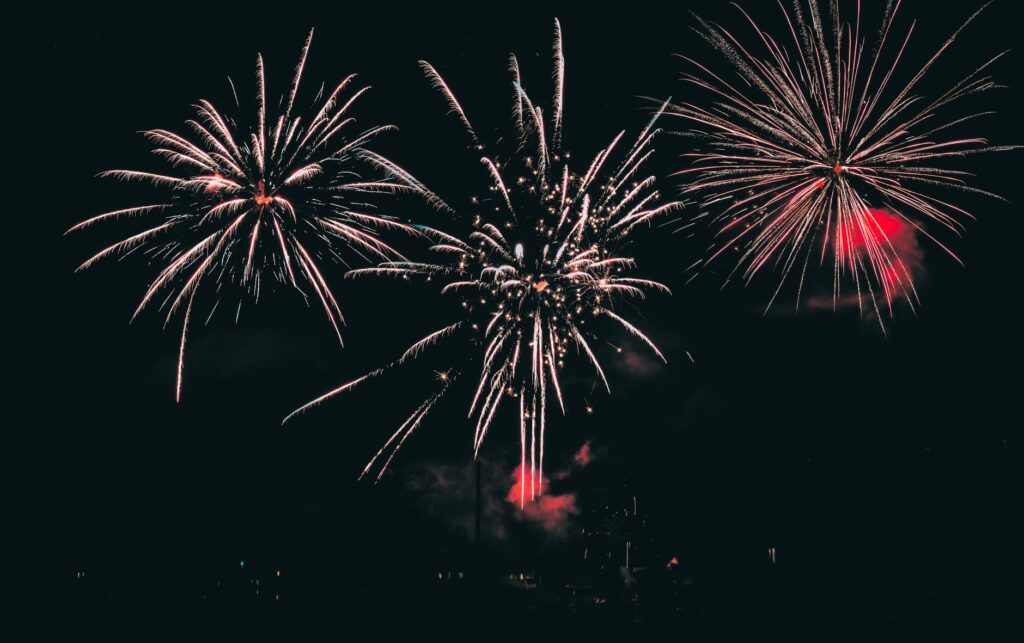 Fireworks lighting the night sky over a US city during the America250 250th anniversary