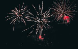 Fireworks lighting the night sky over a US city during the America250 250th anniversary