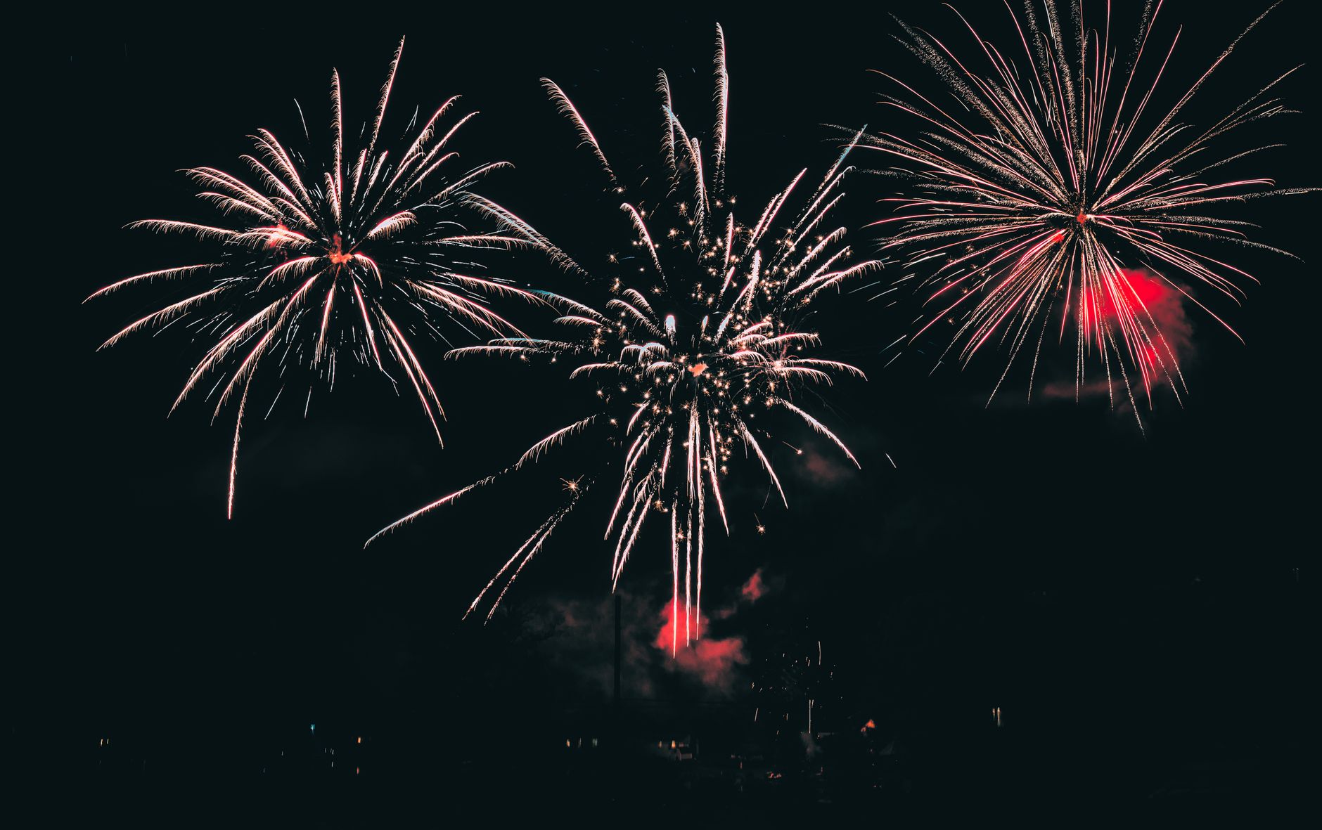 Fireworks lighting the night sky over a US city during the America250 250th anniversary