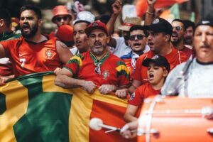 Football fans waving national flags and celebrating at the World Cup 2026 final