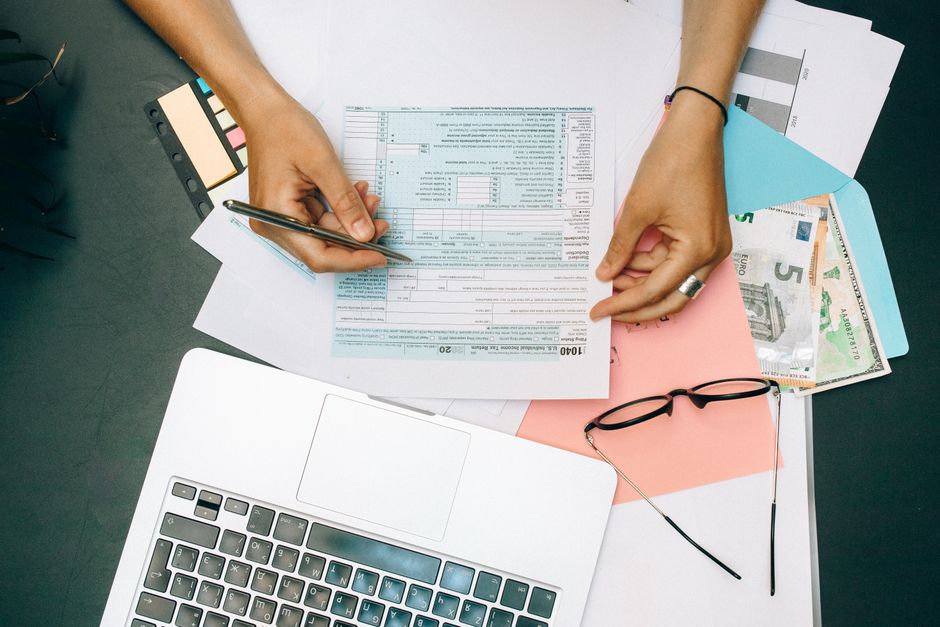 Person gathering passport and payment card before starting an online application