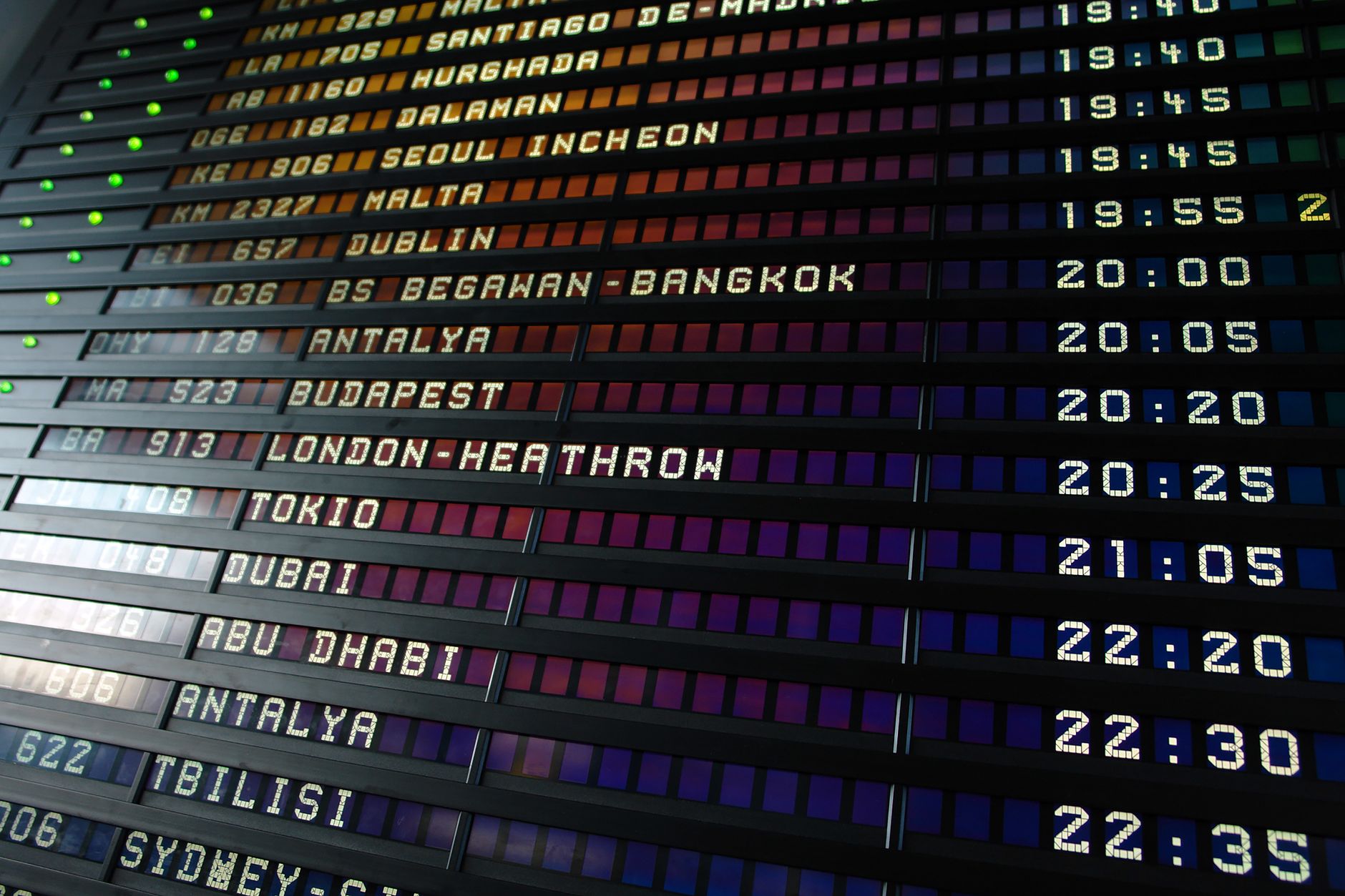 Airport departure board showing flight information during a hurricane-season travel disruption