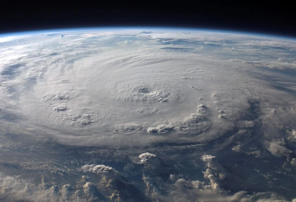 Satellite view of a large swirling hurricane over the Atlantic Ocean near the US coast