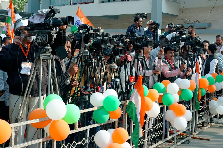 Freelance reporter interviewing a subject on camera for a foreign news outlet