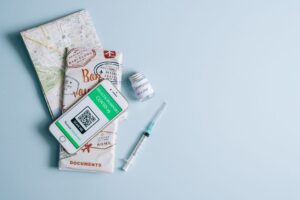 Passport, boarding pass and vaccine card laid out while planning a US trip on an ESTA