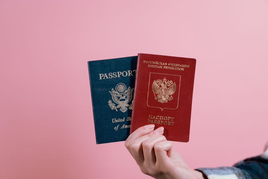 Dual national holding two passports before an international flight