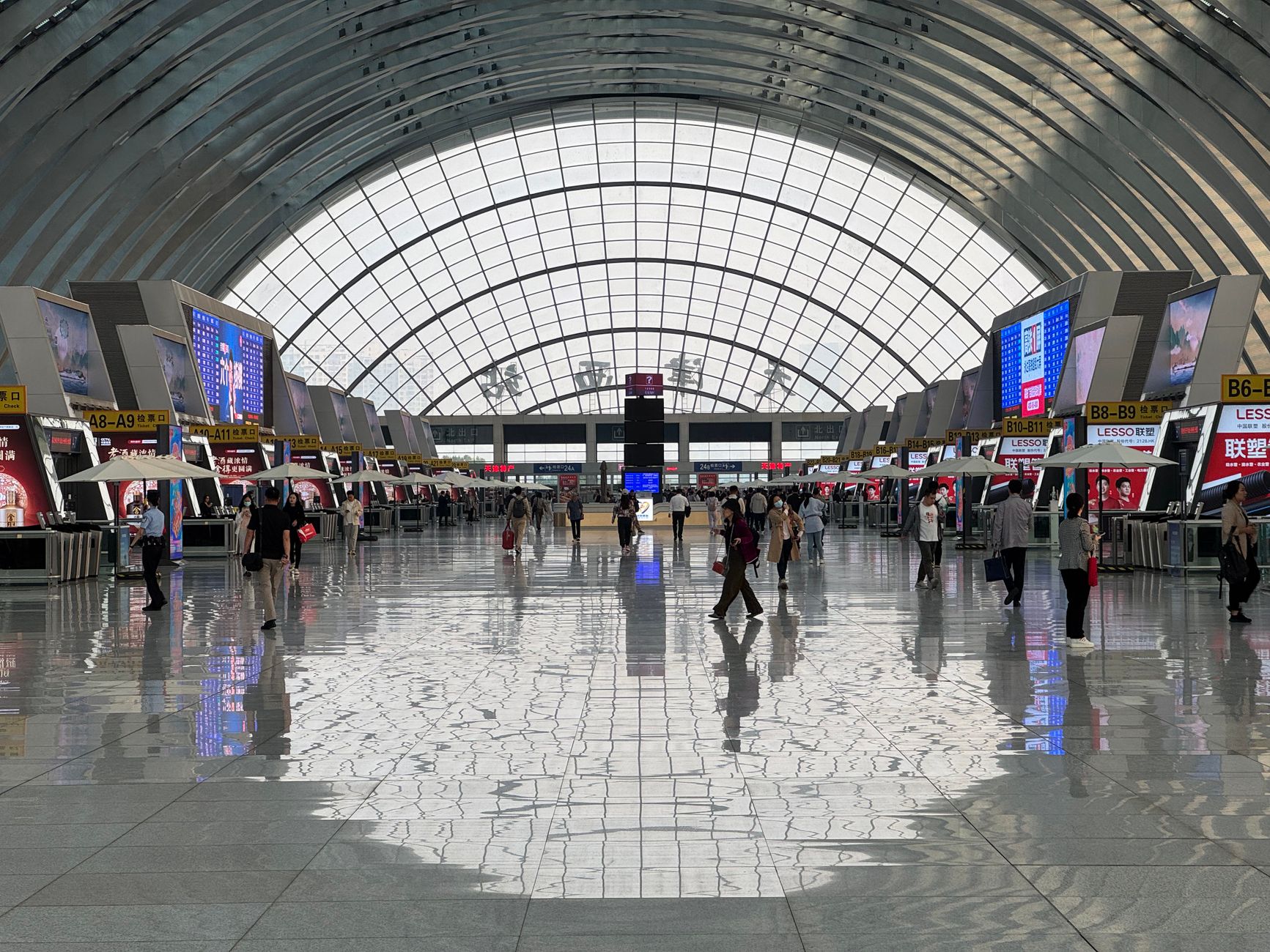 International travelers with luggage in a busy airport terminal