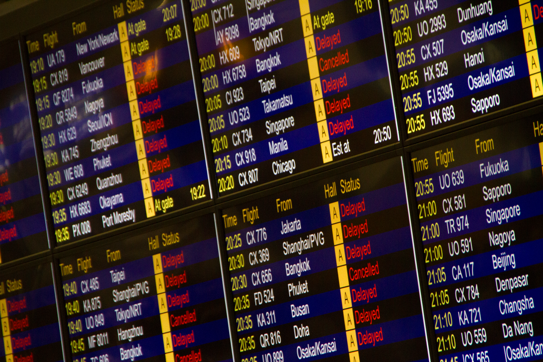 Passengers checking an international departures board at a US airport