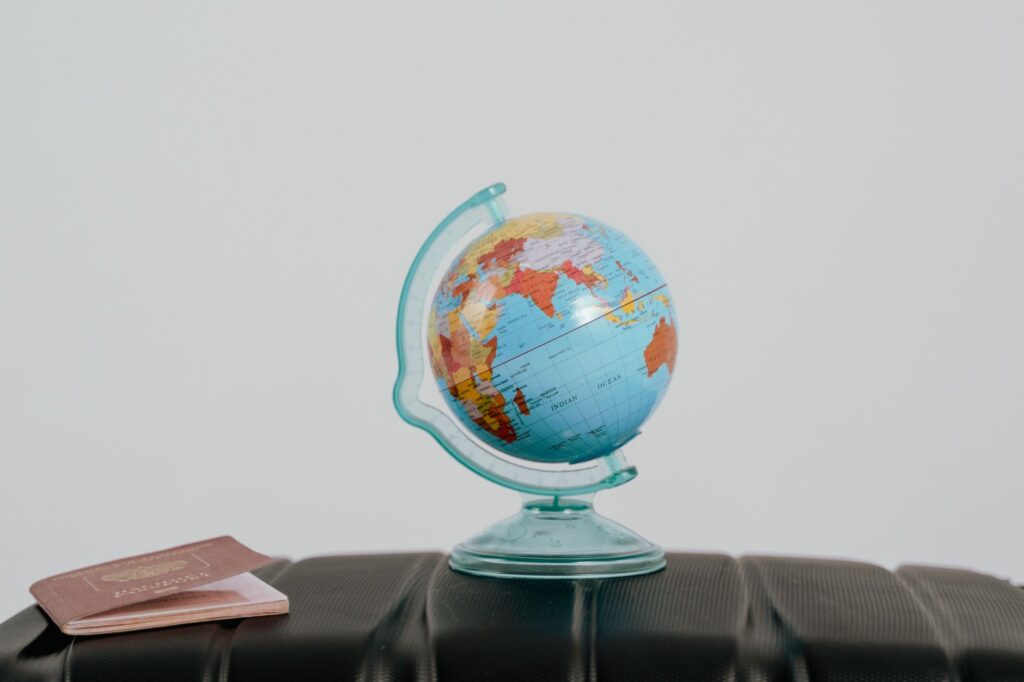 A passport resting on a globe symbolizing worldwide US entry requirements