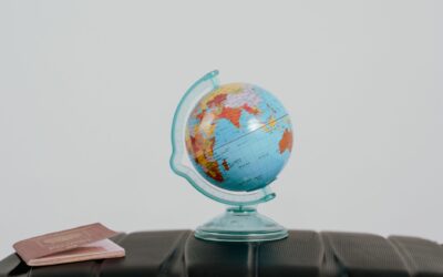 A passport resting on a globe symbolizing worldwide US entry requirements