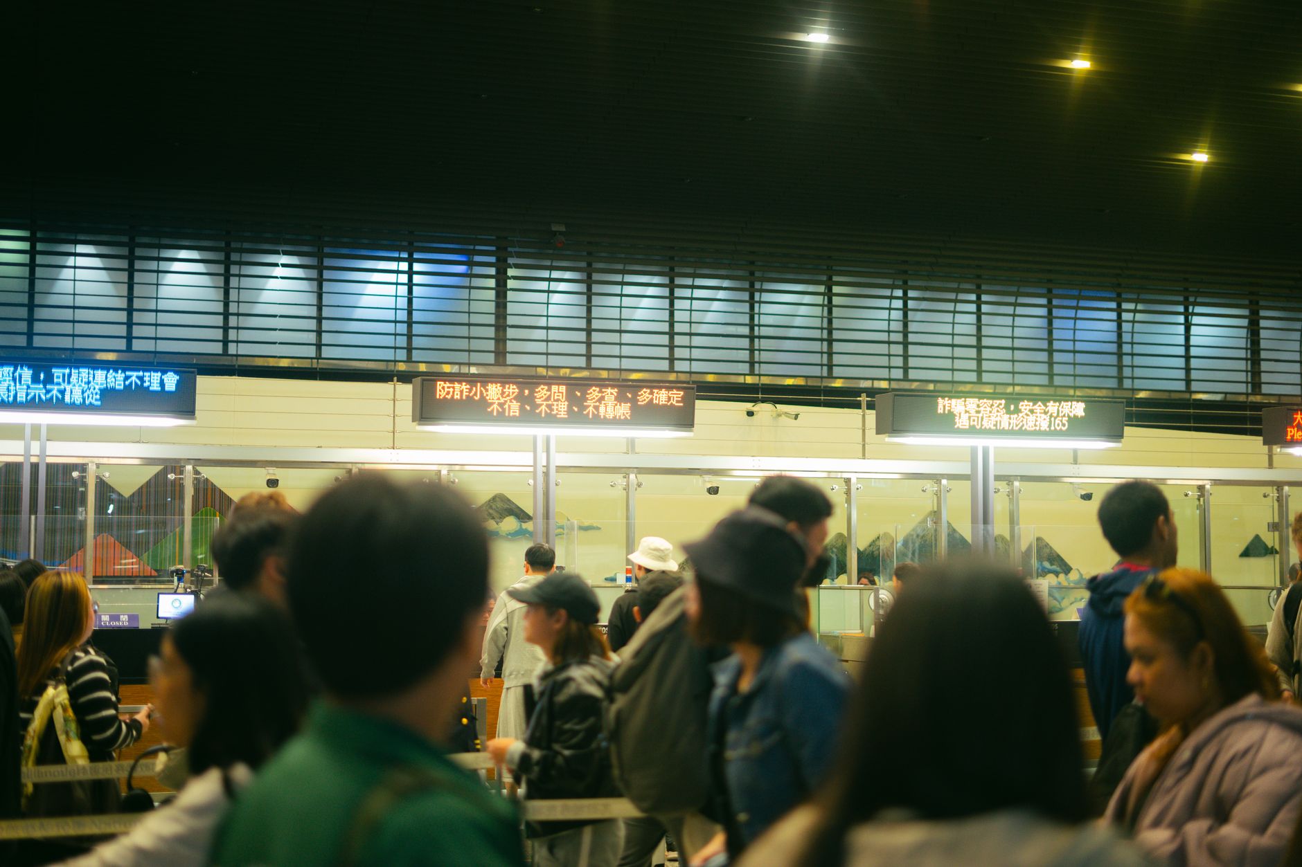 Travelers waiting in line at a US airport passport control hall