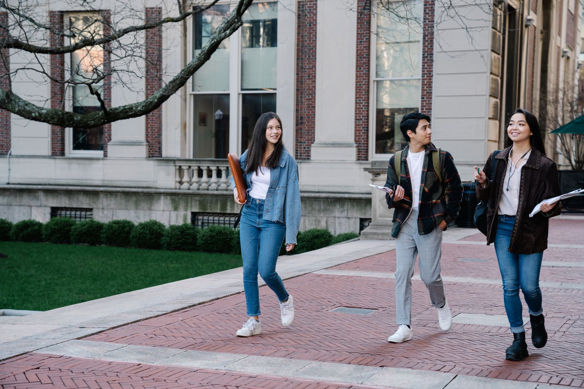 A student with a backpack on a US university campus walkway