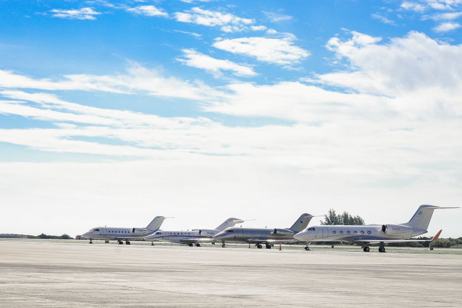 Business traveler boarding a private jet on an airport apron before a flight to the USA