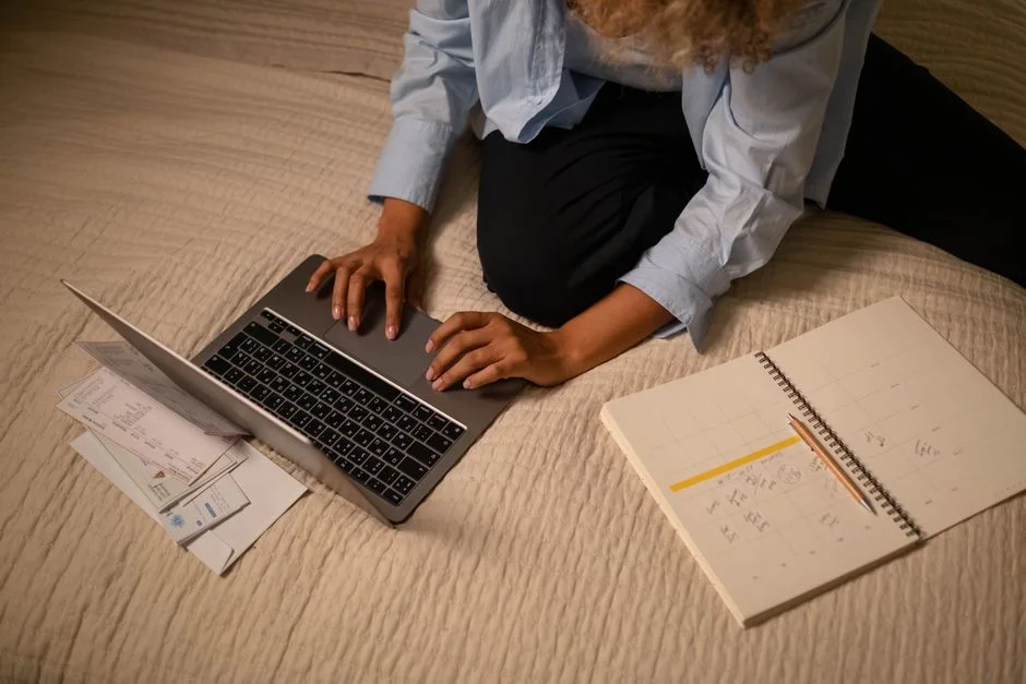 Traveler rebooking flights on a laptop while reviewing a travel authorization