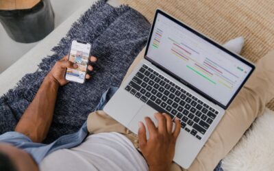 Traveler changing travel plans on a laptop next to a passport and boarding pass