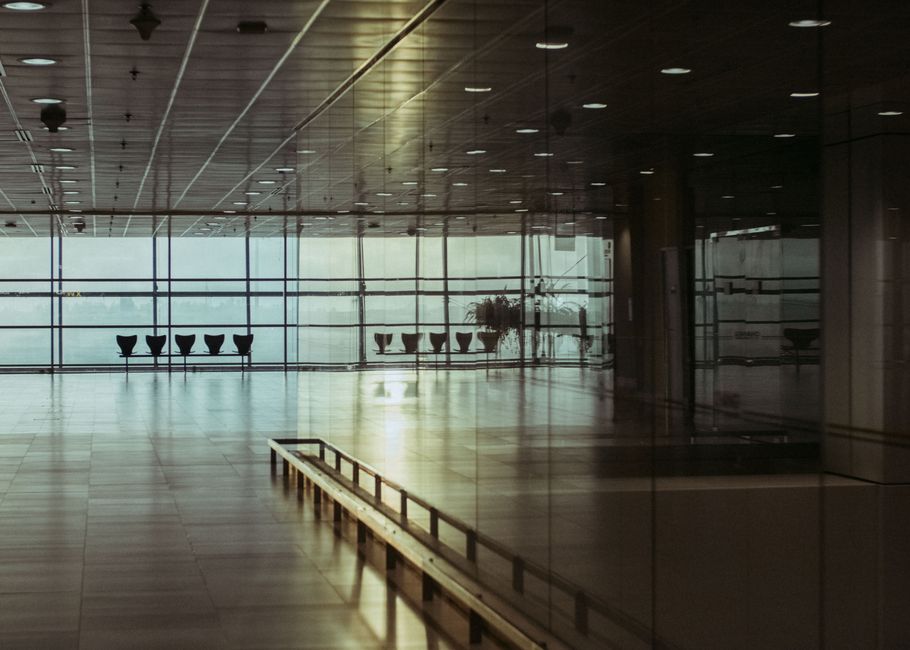 Empty US airport departure hall late at night with closed concessions